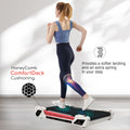Model demonstrating benefits of Honey Comb Deck Cushioning on Egofit ComfortDeck-M2 pearl white treadmill