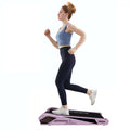 Sakura pink treadmill stored under couch – slim, space-saving design